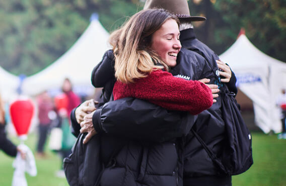 Two people hugging at a Light The Night event.